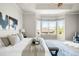Main bedroom boasts large windows, tray ceiling, and stylish decor at 4519 Silver Mountain Loop, Broomfield, CO 80023