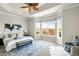 Bright main bedroom with large windows, stylish rug, and an ensuite bathroom at 4519 Silver Mountain Loop, Broomfield, CO 80023