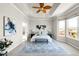 Spacious main bedroom with tray ceiling, stylish decor, and scenic views from large windows at 4519 Silver Mountain Loop, Broomfield, CO 80023