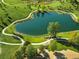 Aerial view of a scenic pond surrounded by lush greenery and walking trails at 4519 Silver Mountain Loop, Broomfield, CO 80023
