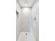Clean and modern shower featuring stone tile walls, rainfall shower head, and a built-in niche at 4519 Silver Mountain Loop, Broomfield, CO 80023