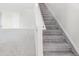 Bright staircase features neutral carpet, white risers and stringers providing a clean and modern design at 4519 Silver Mountain Loop, Broomfield, CO 80023