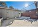 Private patio with snow-covered ground and wooden fence at 10360 E Jewell Ave # 95, Aurora, CO 80247