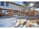 Townhouse exterior with snow-covered landscaping at 10360 E Jewell Ave # 95, Aurora, CO 80247