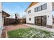 Charming backyard featuring a brick patio, artificial turf, and string lights, perfect for outdoor entertaining at 1375 Perry St, Denver, CO 80204