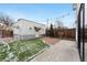 Charming backyard with string lights, artificial grass, and a detached garage at 1375 Perry St, Denver, CO 80204