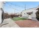 Cozy backyard with brick patio, artificial turf, and a detached structure with string lights at 1375 Perry St, Denver, CO 80204