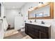 Modern bathroom with a double vanity, white subway tile shower, and neutral colored rugs at 1375 Perry St, Denver, CO 80204