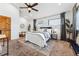 Comfortable main bedroom featuring a ceiling fan, large windows, and neutral decor at 1375 Perry St, Denver, CO 80204