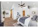 Spacious main bedroom with a ceiling fan, barn door, and plenty of natural light at 1375 Perry St, Denver, CO 80204