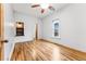 Empty bedroom with hardwood floors, a ceiling fan, and bright white walls at 1375 Perry St, Denver, CO 80204