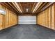 Spacious garage with exposed wooden beams and a durable, easy-to-clean black tiled floor at 1375 Perry St, Denver, CO 80204