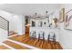 Modern kitchen featuring an island with seating, white cabinets and stainless steel appliances at 1375 Perry St, Denver, CO 80204