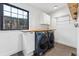 Bright laundry room with front-load washer and dryer, wooden countertop, and ample lighting at 1375 Perry St, Denver, CO 80204