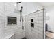 Close-up of a modern shower with white subway tile, black hardware, and a built-in shelf at 1375 Perry St, Denver, CO 80204