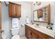 Well-lit bathroom features a wood vanity, mirror, and ample storage space at 10058 Lewis St, Broomfield, CO 80021