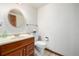 Bathroom featuring a wooden vanity and toilet with fixtures at 10058 Lewis St, Broomfield, CO 80021