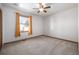 Bright bedroom with neutral carpet, a ceiling fan, and natural light from a window at 10058 Lewis St, Broomfield, CO 80021