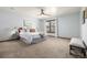 Light filled bedroom with soft blue walls, white bedding, and a modern ceiling fan at 10058 Lewis St, Broomfield, CO 80021