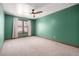 Spacious bedroom featuring neutral carpet, a ceiling fan, and a window with curtains at 10058 Lewis St, Broomfield, CO 80021