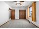 Bedroom featuring neutral carpet, a ceiling fan, and a closet with wood doors at 10058 Lewis St, Broomfield, CO 80021