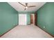 Bedroom featuring neutral carpet, a ceiling fan, a closet, and an entrance door at 10058 Lewis St, Broomfield, CO 80021