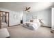 Calming bedroom features blue walls, carpeted floors, white bedding, and a wood ceiling fan at 10058 Lewis St, Broomfield, CO 80021