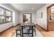 Sunlit dining room with hardwood floors, a wooden table, and a window providing a bright and inviting atmosphere at 10058 Lewis St, Broomfield, CO 80021