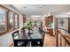 Bright dining area featuring a hardwood floor, large window, and modern black table with seating for four at 10058 Lewis St, Broomfield, CO 80021