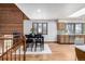 Open-concept dining room featuring hardwood floors and a cozy seating arrangement next to the modern kitchen at 10058 Lewis St, Broomfield, CO 80021