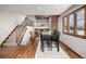 Cozy dining room featuring hardwood floors, large windows, and easy access to the living room and kitchen area at 10058 Lewis St, Broomfield, CO 80021