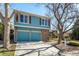 Charming two-story home featuring blue siding, red shutters, and a two-car garage at 10058 Lewis St, Broomfield, CO 80021