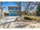 Charming two-story home featuring blue siding, red shutters, and a two-car garage at 10058 Lewis St, Broomfield, CO 80021