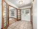 Inviting foyer with tiled floor and decorative glass paneled doors leading to living areas at 10058 Lewis St, Broomfield, CO 80021