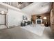 Bright living room with wood paneling and cozy seating, open to dining area above at 10058 Lewis St, Broomfield, CO 80021