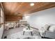 Inviting living room area featuring a wooden ceiling, railing, and an ornate area rug beneath comfortable seating at 10058 Lewis St, Broomfield, CO 80021