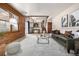 Open-concept living room with wood paneling, leading to a dining area and backyard access at 10058 Lewis St, Broomfield, CO 80021