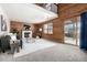 Cozy living room with wood paneling, a fireplace, and sliding glass doors at 10058 Lewis St, Broomfield, CO 80021