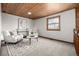 Cozy living room with a wood ceiling, natural light, and comfortable chairs situated on top of an elegant rug at 10058 Lewis St, Broomfield, CO 80021