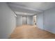 Modern basement area with beautiful flooring and a doorway leading to a bathroom at 13464 W Virginia Dr, Lakewood, CO 80228