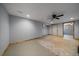 Spacious basement area with a neutral color scheme, ceiling fan, and doorway leading to another room at 13464 W Virginia Dr, Lakewood, CO 80228