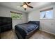 Neutral bedroom featuring windows offering natural light with a black desk and furnishings at 13464 W Virginia Dr, Lakewood, CO 80228