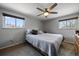 Comfortable bedroom with neutral walls, carpeted floors, and natural light from two windows at 13464 W Virginia Dr, Lakewood, CO 80228