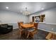 Cozy dining area with modern lighting and gray walls adjacent to large window and open floor plan at 13464 W Virginia Dr, Lakewood, CO 80228