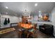 Dining area with wood table, chairs, modern lighting, open floor plan, and wall with a hanging coat at 13464 W Virginia Dr, Lakewood, CO 80228