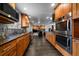 View of the kitchen with granite countertops and stainless steel appliances and a fireplace nearby at 13464 W Virginia Dr, Lakewood, CO 80228