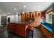 Custom kitchen with granite island and seating, lots of wood cabinets, and a breakfast nook bench seat at 13464 W Virginia Dr, Lakewood, CO 80228