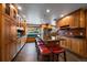 Gourmet kitchen with a large island featuring seating, stainless steel appliances, and custom cabinetry at 13464 W Virginia Dr, Lakewood, CO 80228