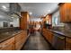 Updated kitchen with wood cabinets, stainless steel appliances, and an open design to adjacent rooms at 13464 W Virginia Dr, Lakewood, CO 80228