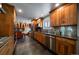 Modern kitchen featuring custom cabinets, stainless steel appliances, and granite countertops and backsplash at 13464 W Virginia Dr, Lakewood, CO 80228
